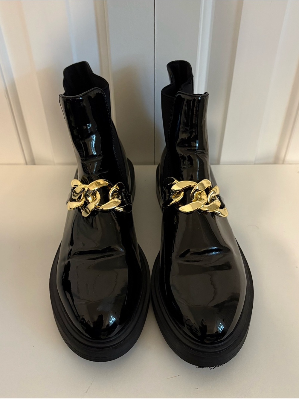 STEVE MADDEN Black Patent Chelsea Boots with Gold Chain Accent